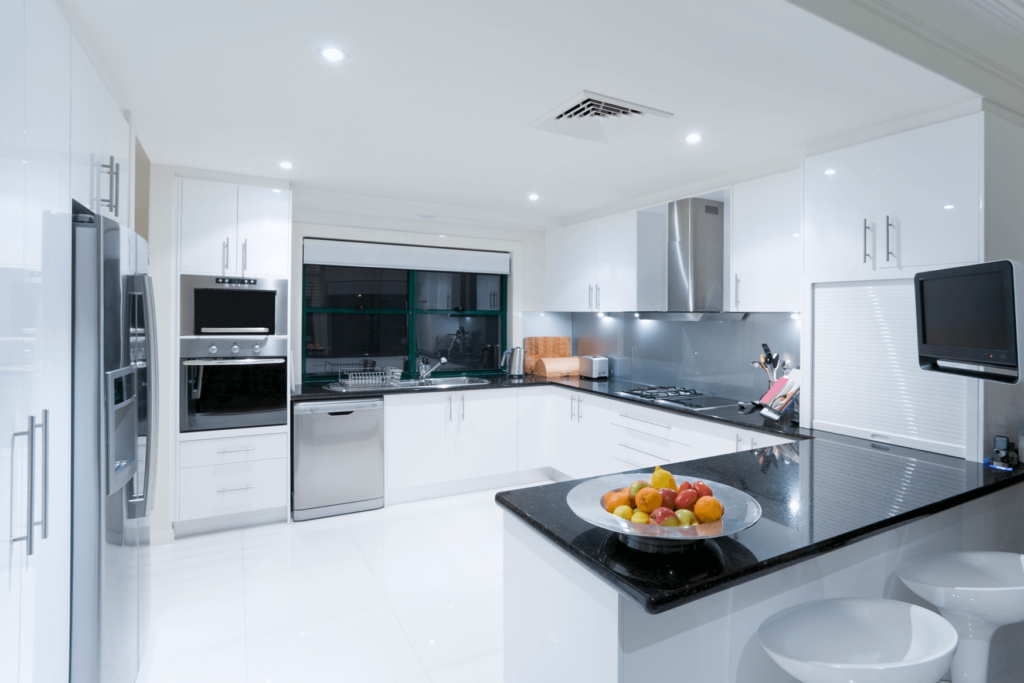 the kitchen has a black granite countertop and stainless steel appliances, in the style of minimalist purity, uhd image, white and silver, harsh lighting, layered translucency, crisp and clean look, crisp and clean look