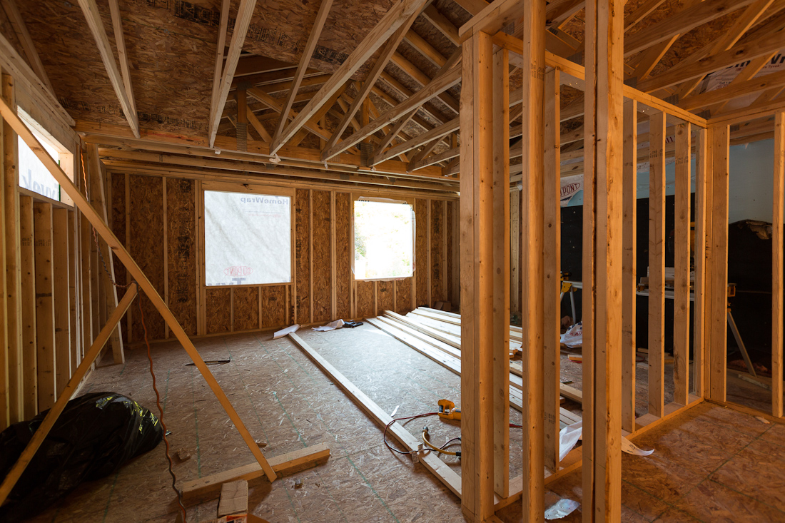 an unfinished and framed room with some framing, in the style of expert draftsmanship, weather core, jump cuts, bold structural designs, expansive, wood