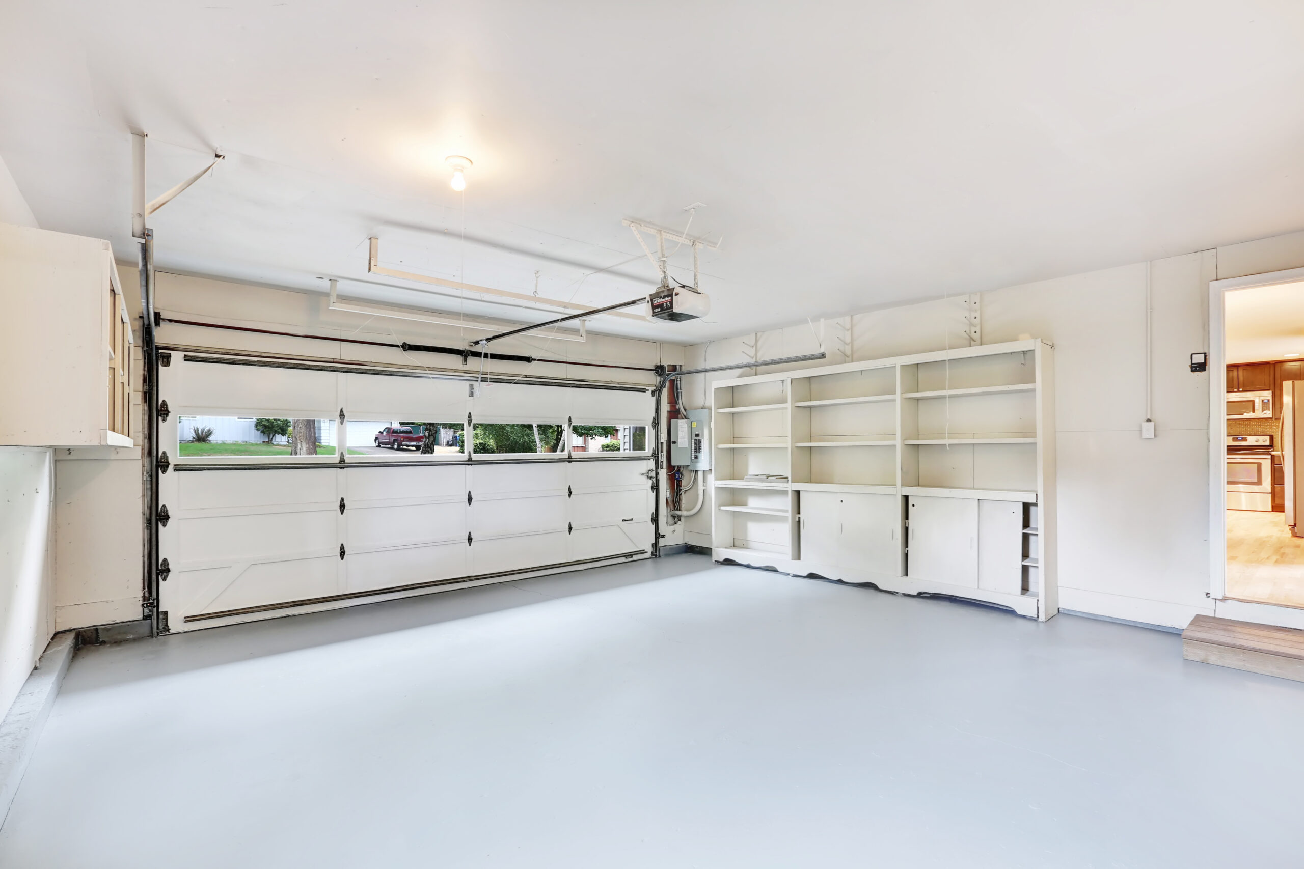 empty garage interior with cabinets and shelves