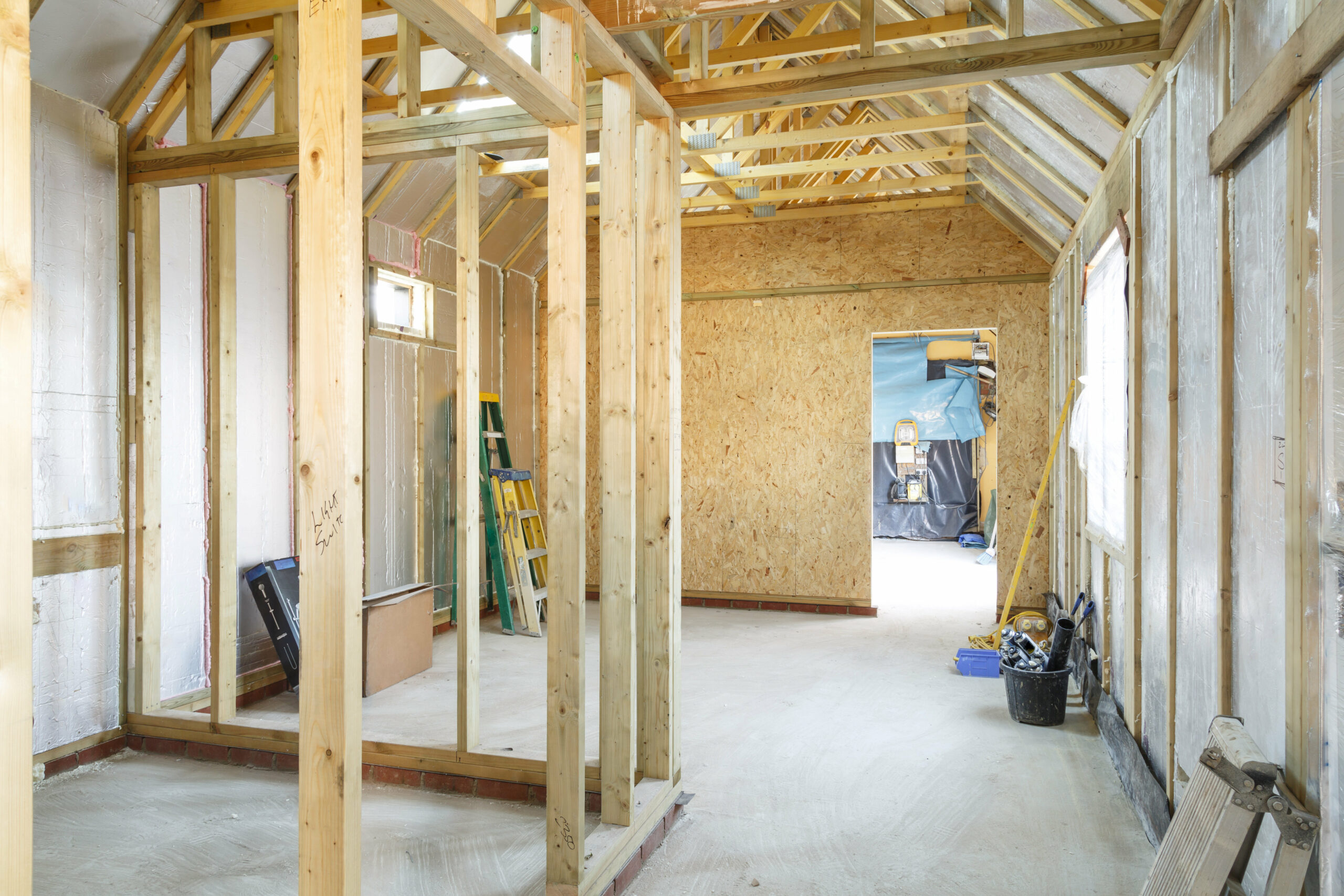 house that is under construction has wooden framing in it, in the style of domestic interiors, dark cyan and light beige, textured surfaces, light beige and yellow, natural lighting, rubens, raw materials