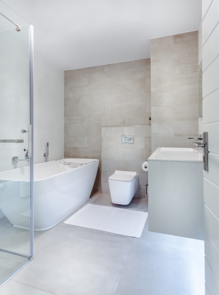 elegant bathroom with glass entry door and wooden white furniture